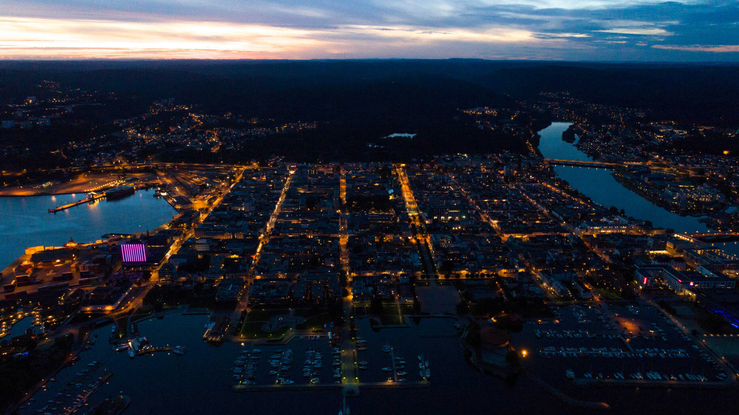 A birds eye view of a city lit up at night